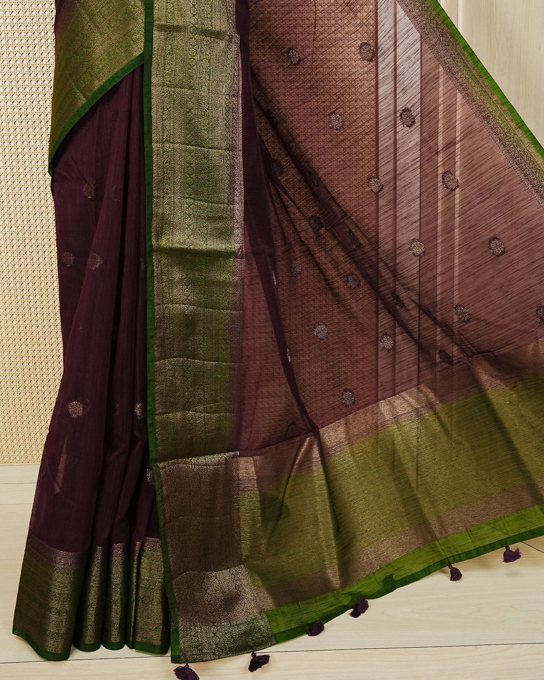 Wine colour semi linen saree thread motifs on body, contrast mehndi green colour gold zari border, rich pallu comes with matching blouse piece