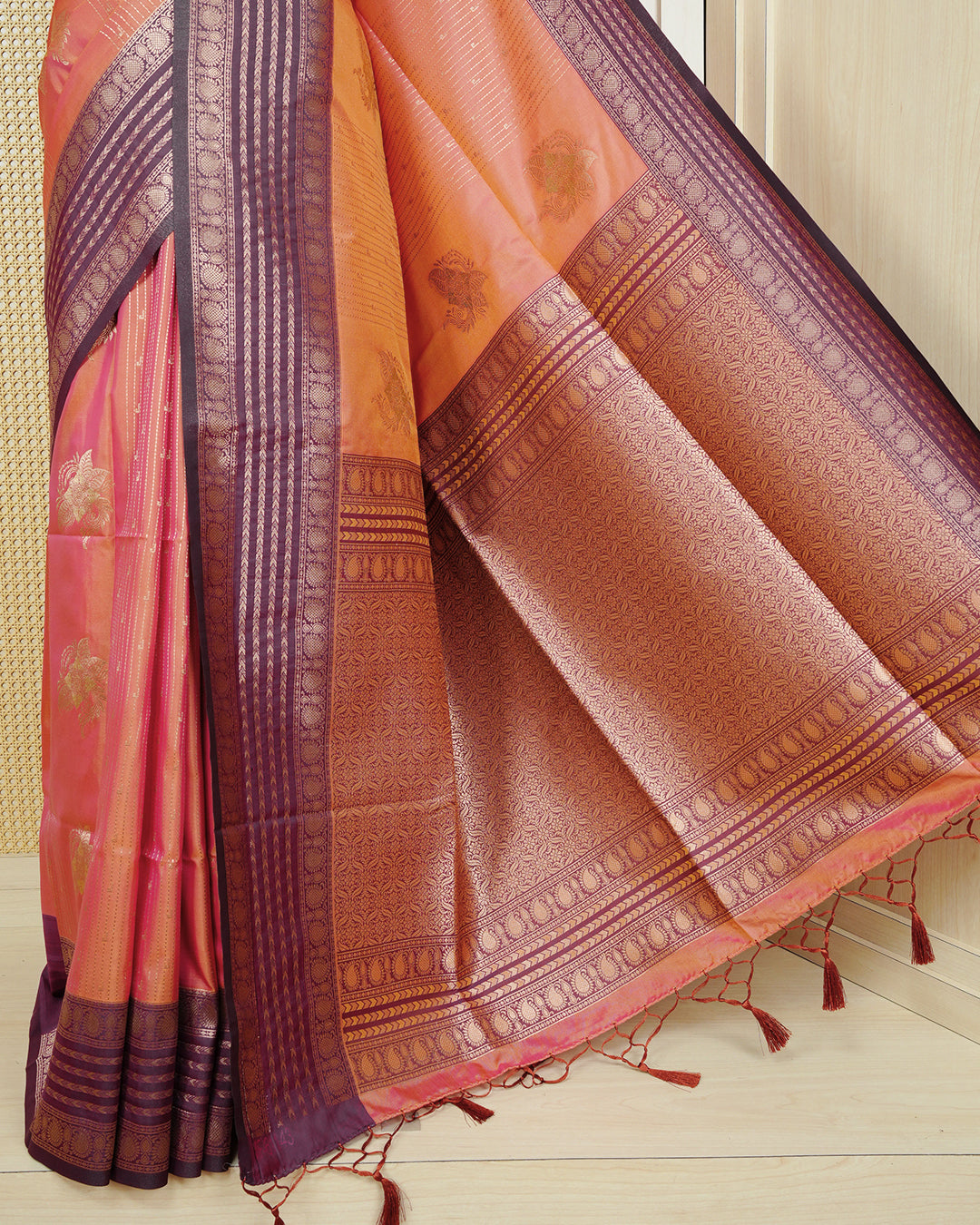 Rust orange & gold double shade Mulberry silk saree featuring floral gold zari patterns on body, paired with contrast purple colour with traditional border, comes with matching blouse piece.