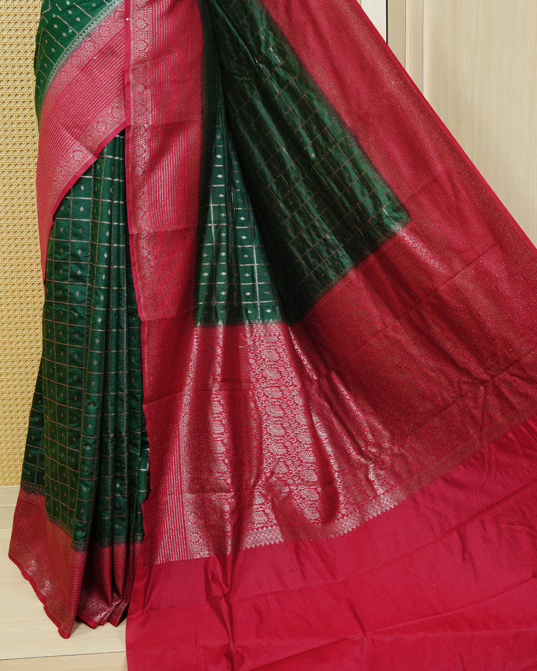 Dark green Colour Semi georgette Saree having zari check with buttas pattern on body, contrast red colour floral designed border, Rich Pallu comes with Matching Blouse piece.