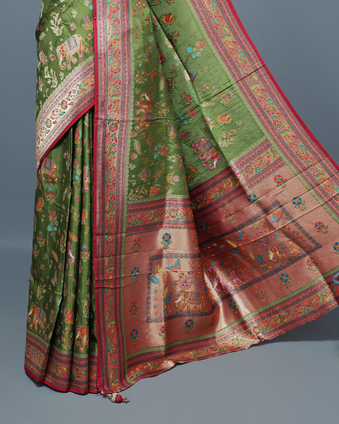 Olive  Colour Pashmina Saree featuring a Patterned body, complemented by Contrast Magenta colour with Floral pattern & gold zari on border and Pallu, comes with matching blouse piece.