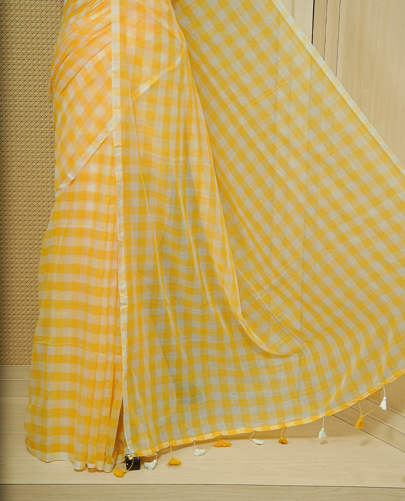 Yellow & white Mul cotton saree featuring Small Check pattern across body, complemented by Elegant Tassels.