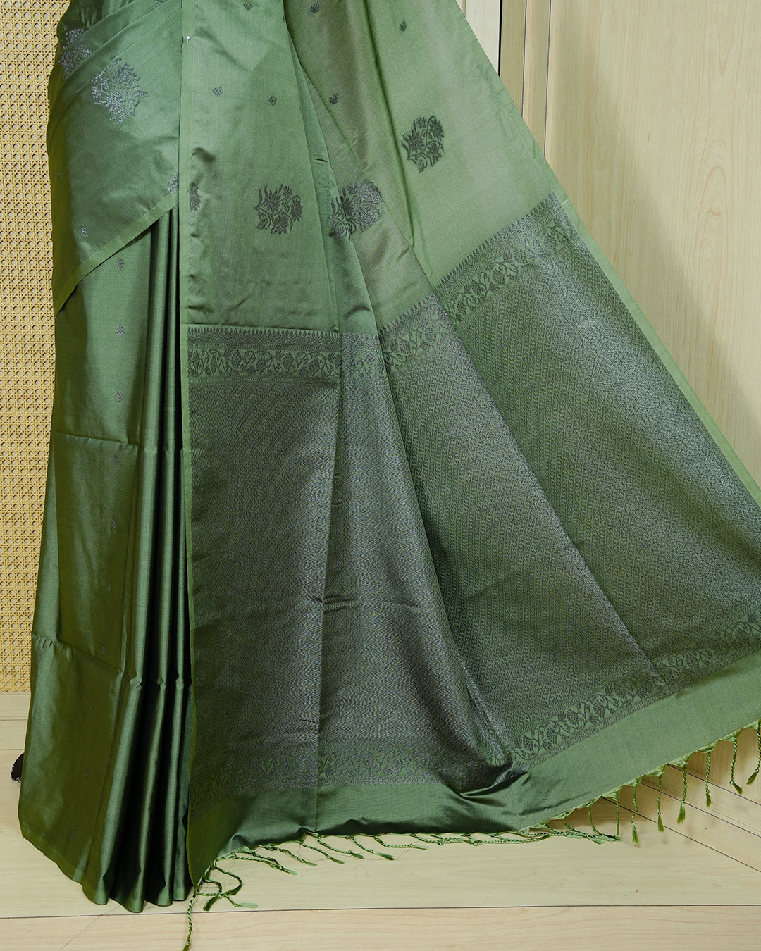 Pastel green colour soft silk saree featuring antique zari motifs on body with contrast self colour pallu & paired with matching blouse piece.