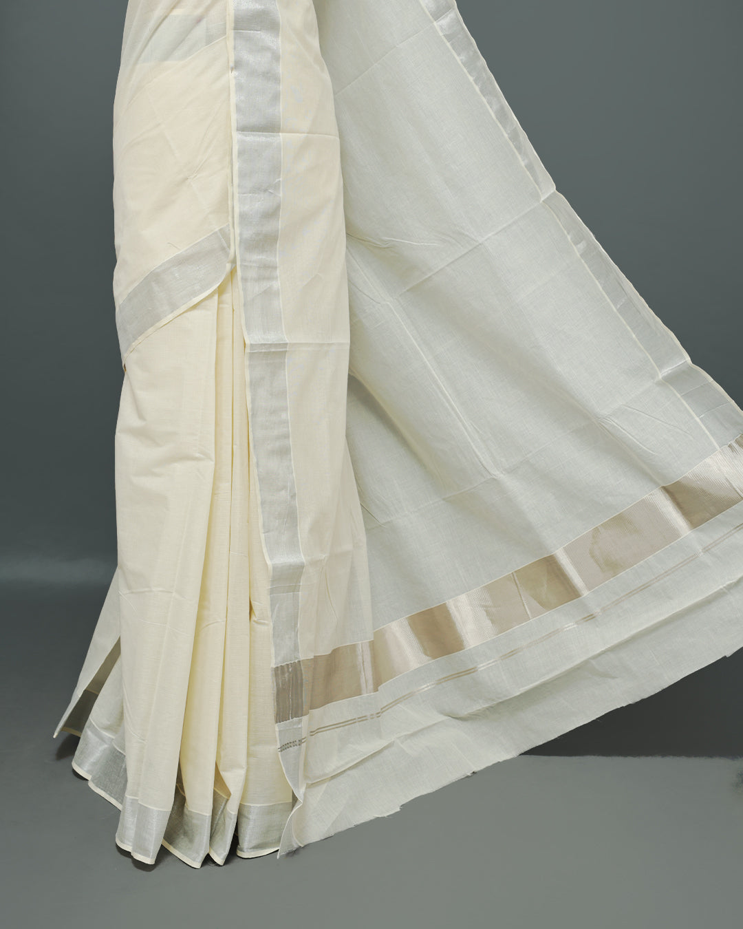 Cream colour Kerala saree Featuring an Elegant plain body, complemented by a classic Silver & Rose gold zari border, matching blouse piece.