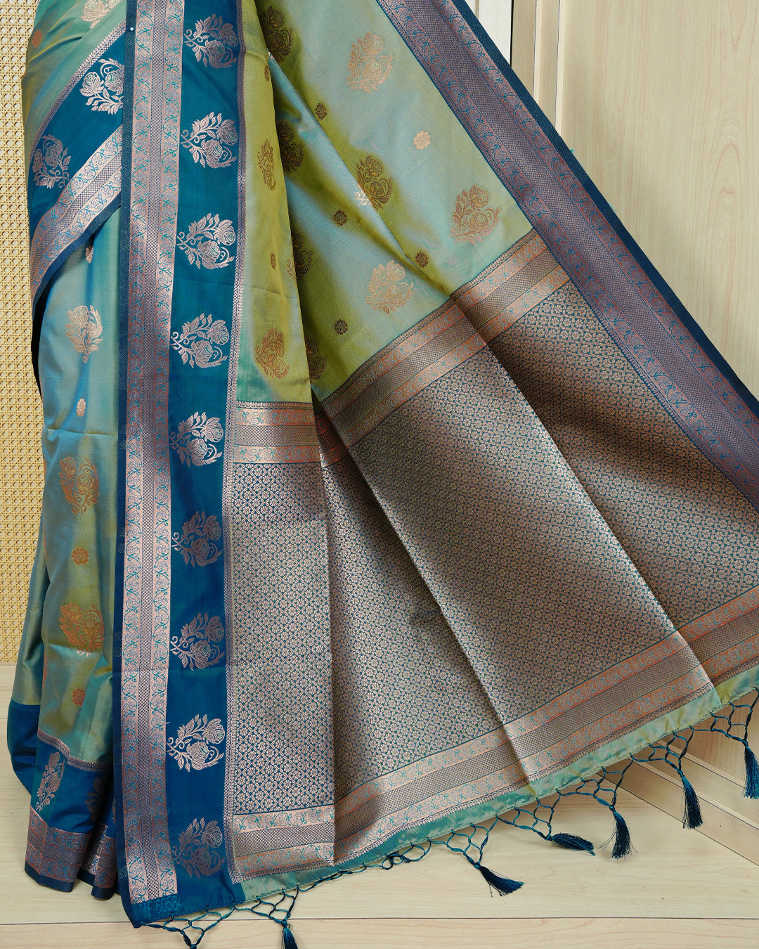 Light green & gold double shade Mulberry silk saree featuring floral gold zari patterns on body, paired with contrast teal colour with traditional border, comes with matching blouse piece.