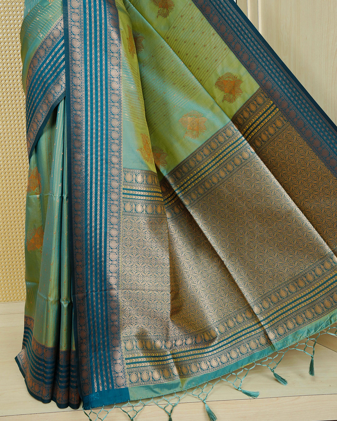 Green & gold double shade Mulberry silk saree featuring gold floral zari patterns on body , paired with contrast bottle green colour with traditional border, comes with matching blouse piece.