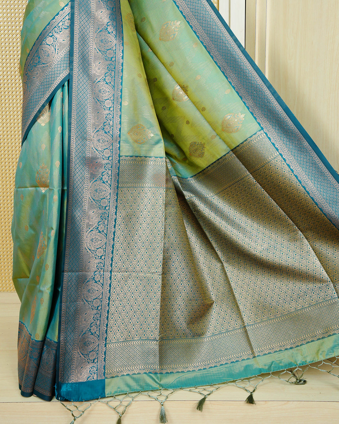 Green & gold double shade Mulberry silk saree featuring gold zari patterns on body , paired with contrast teal colour with traditional border, comes with matching blouse piece.