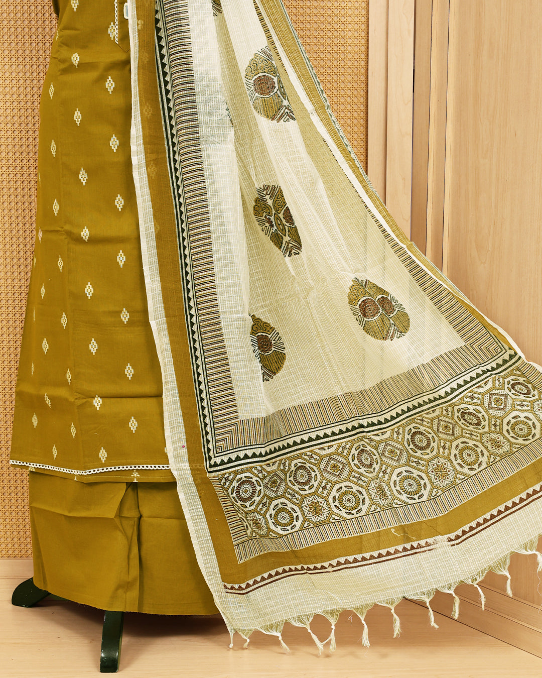 Mustard colour Cotton salwar material featuring Thread with mirror work on body, paired with matching bottom & dupatta.