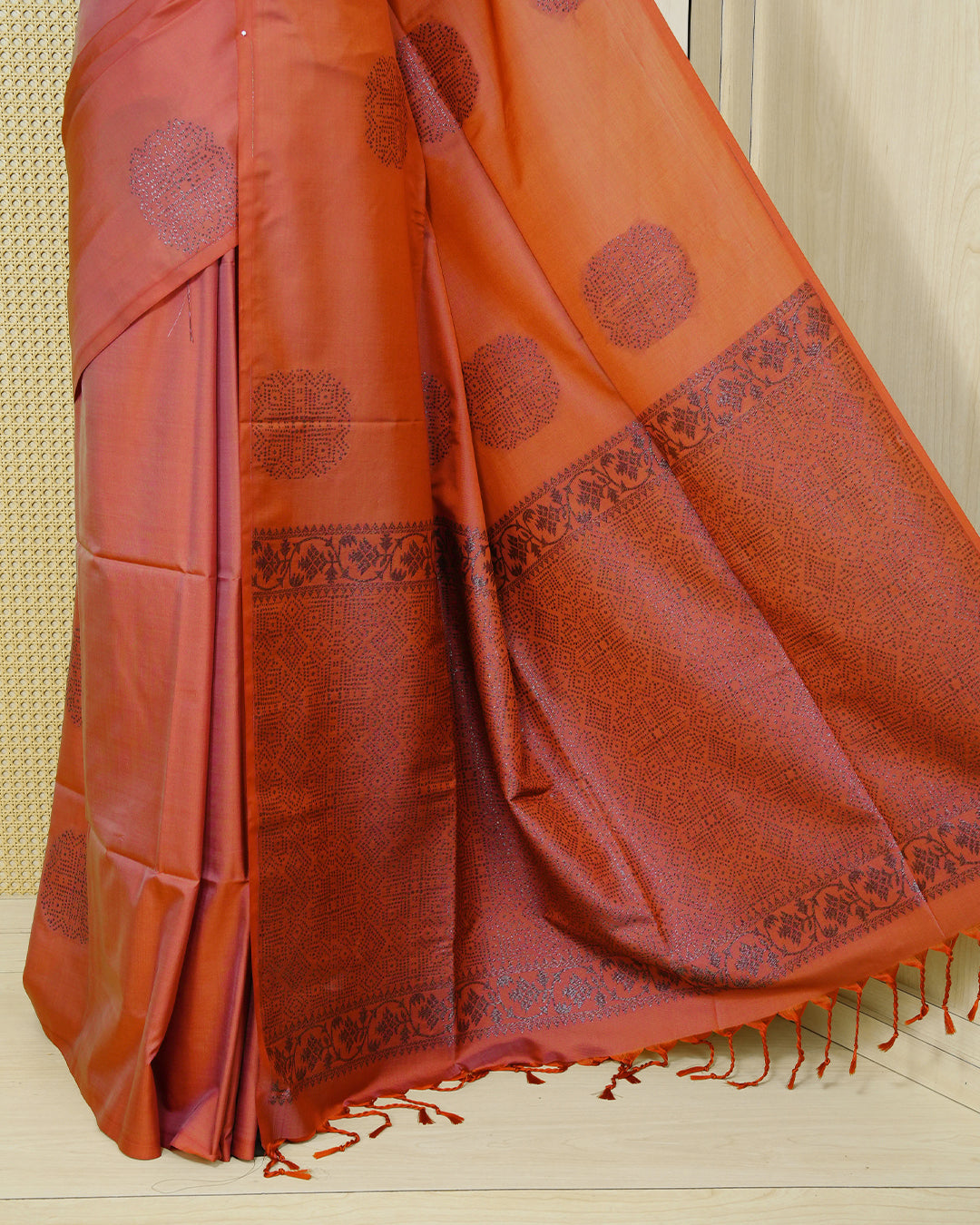 Brick orange colour soft silk saree featuring antique zari motifs on body with contrast self colour pallu & paired with matching blouse piece.