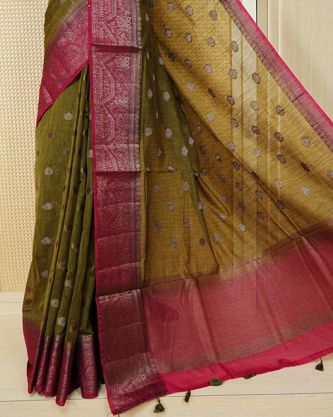 Olive green colour semi linen saree thread motifs on body, contrast pink colour gold zari border, rich pallu comes with matching blouse piece