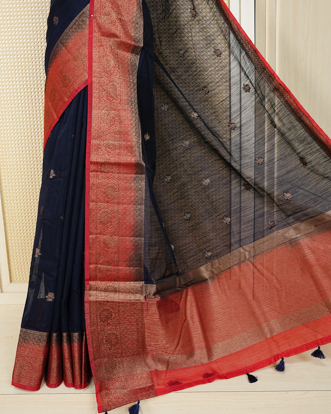 Navy blue colour semi linen saree thread motifs on body, contrast red colour gold zari border, rich pallu comes with matching blouse piece