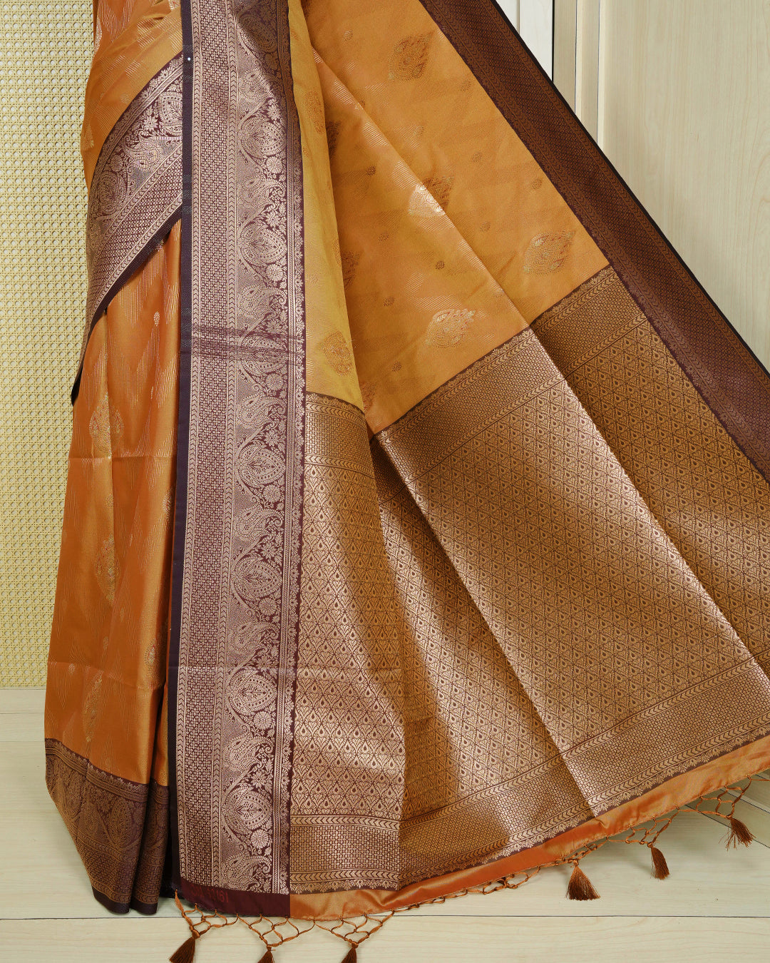 Copper & gold double shade Mulberry silk saree featuring floral gold zari patterns on body, paired with contrast teal colour with traditional border, comes with matching blouse piece.