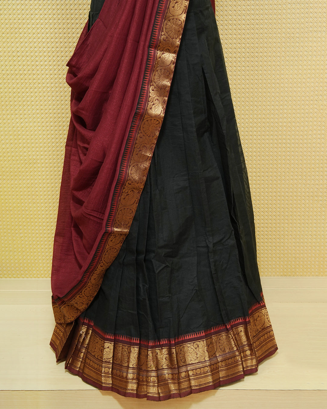Black Colour chettinad cotton Semi stitched dhavani set featuring Contrast Maroon with Gold zari border skirt, comes with Matching blouse piece & dupatta.