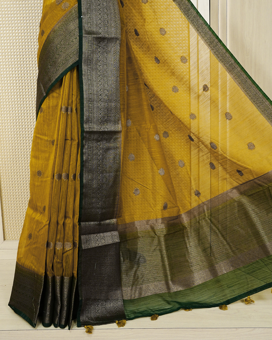 Mustard yellow colour semi linen saree thread motifs on body, contrast Dark green colour gold zari border, rich pallu comes with matching blouse piece