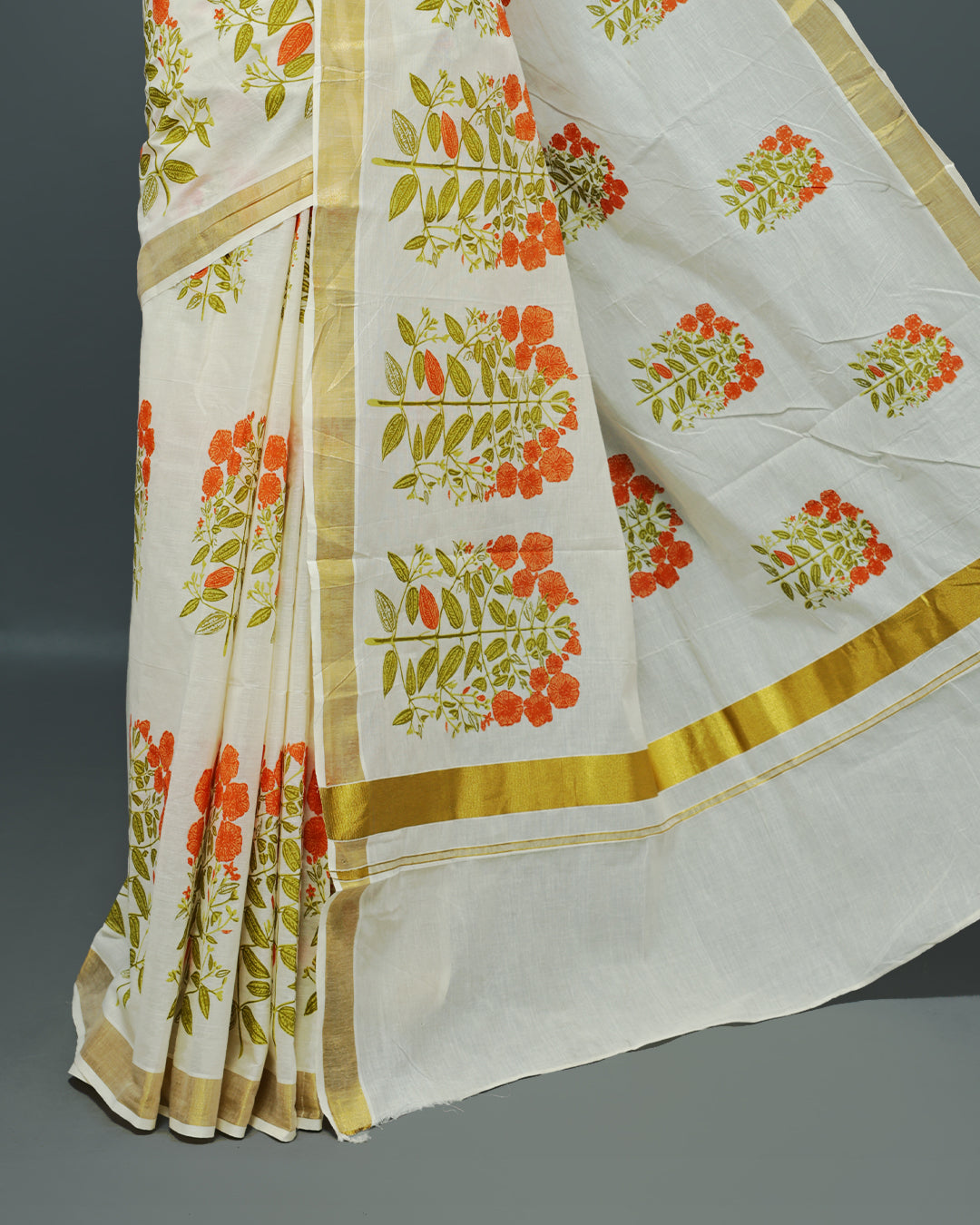 Cream colour Cotton kerala saree featuring Orange colour floral Print on the body, complemented by a gold zari Border, paired with a matching blouse piece.