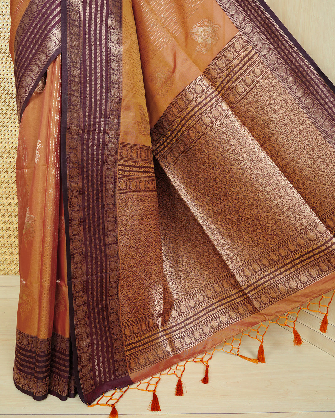Rust orange & gold double shade Mulberry silk saree featuring floral gold zari patterns on body, paired with contrast maroon colour with traditional border, comes with matching blouse piece.