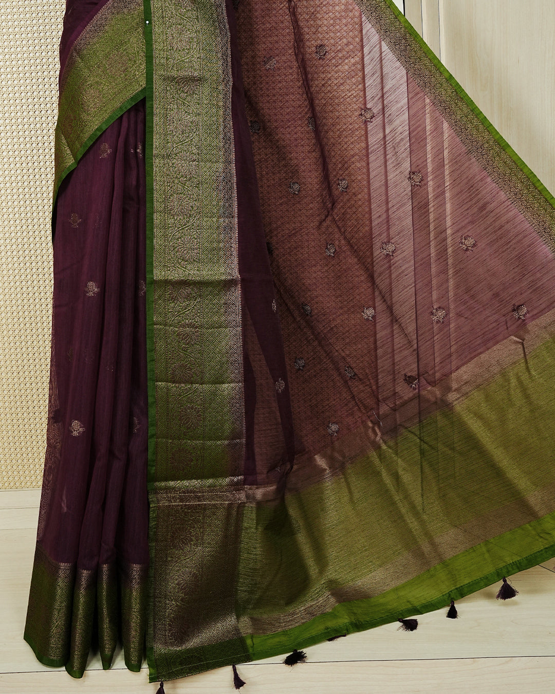 Wine colour semi linen saree thread motifs on body, contrast mehndi green colour gold zari border, rich pallu comes with matching blouse piece