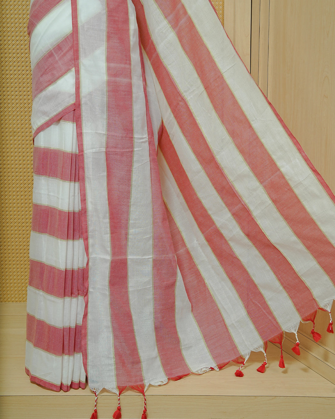 Off White & Red Striped Mul Cotton Saree featuring broad alternating white and Red Stripes, subtle zari detailing, and Finished With red tassels.