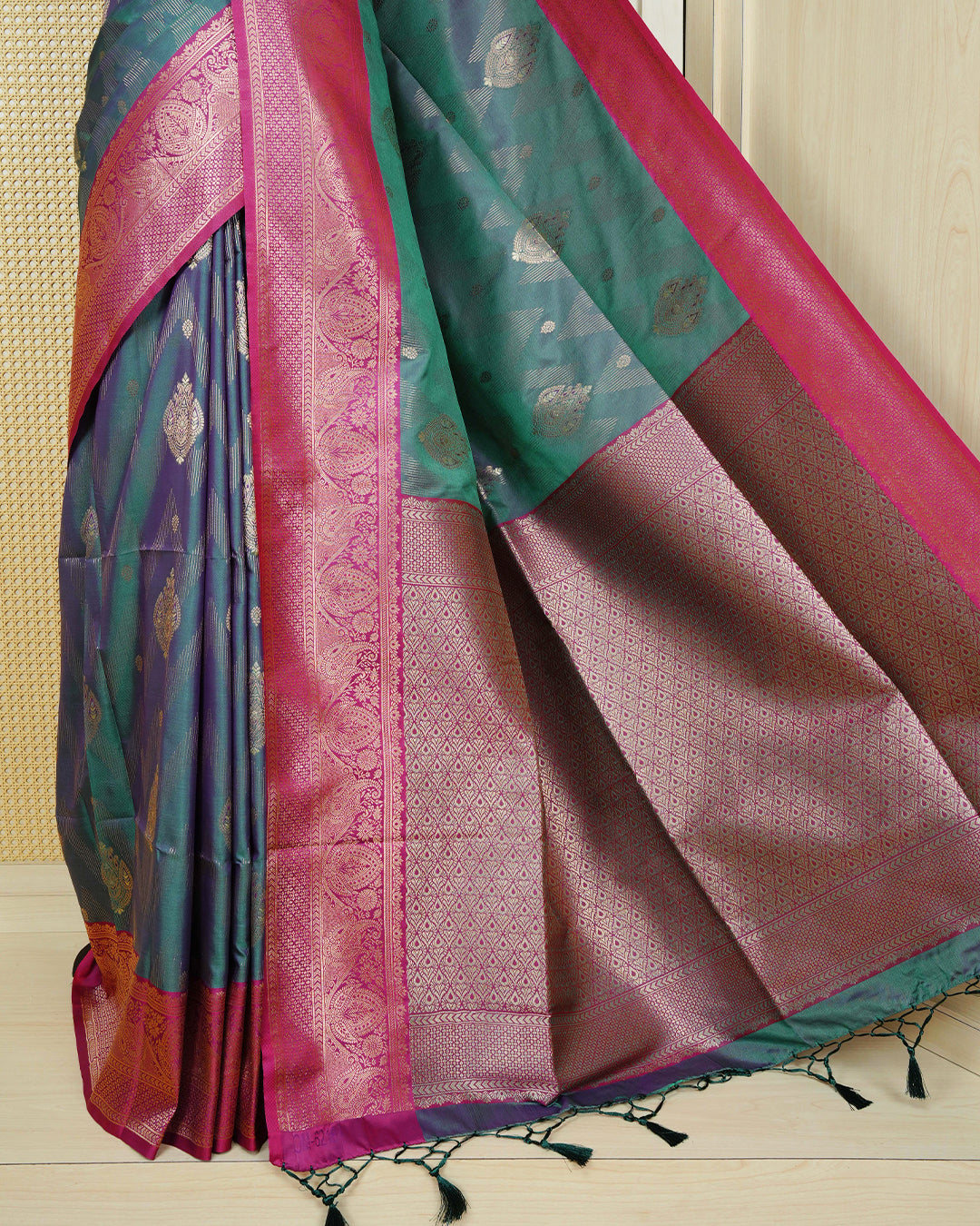 Green colour Mulberry silk saree featuring gold floral zari patterns on body, paired with contrast magenta colour with traditional border, comes with matching blouse piece.