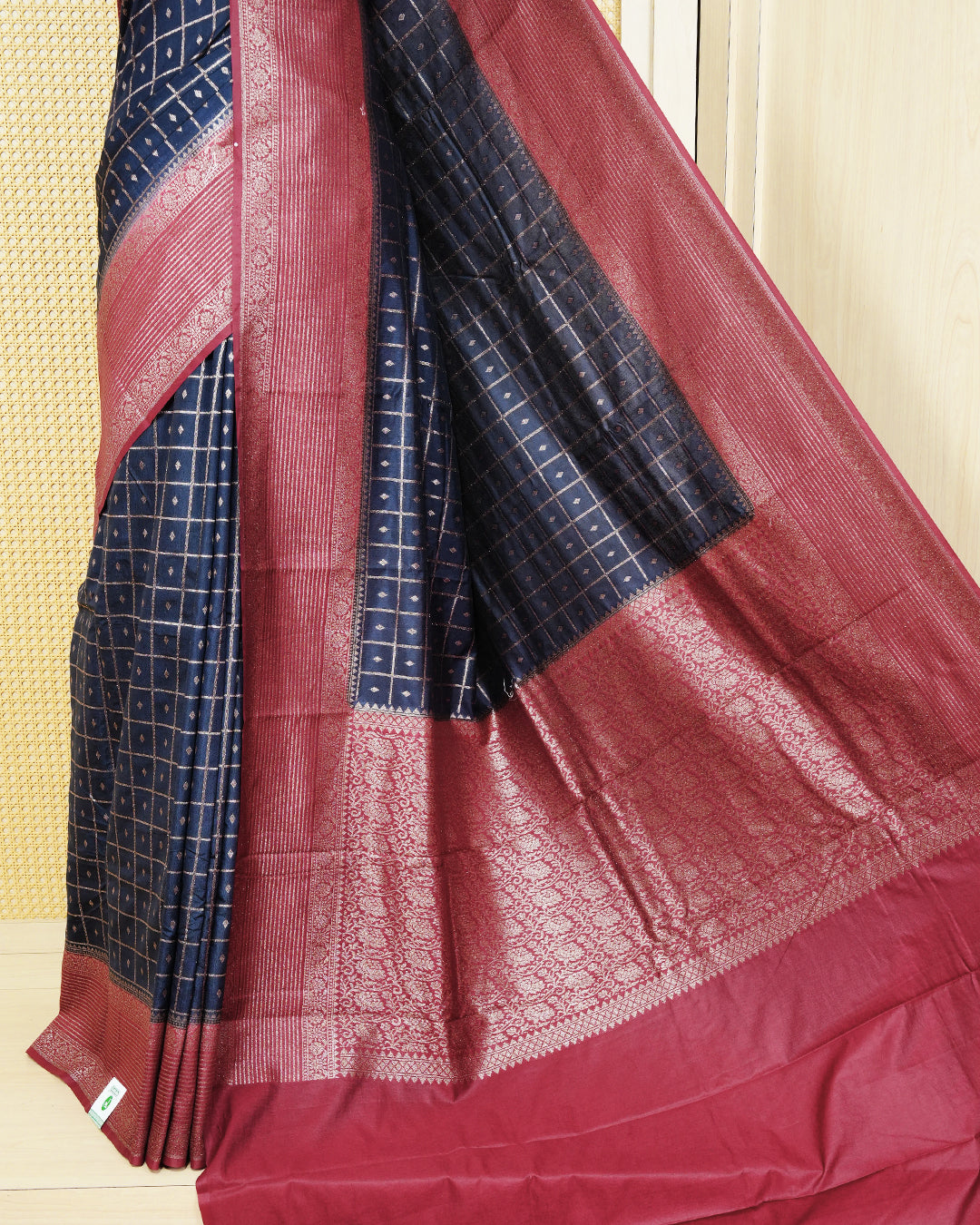 Navy blue Colour Semi georgette Saree having zari check with buttas pattern on body, contrast maroon colour floral designed border, Rich Pallu comes with Matching Blouse piece.