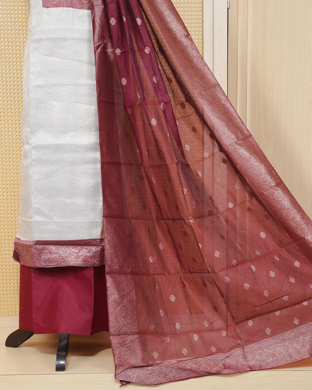 Cream colour salwar material featuring Plain Body Design without border, Maroon colour work on neck portion, paired with matching bottom and elegant dupatta.