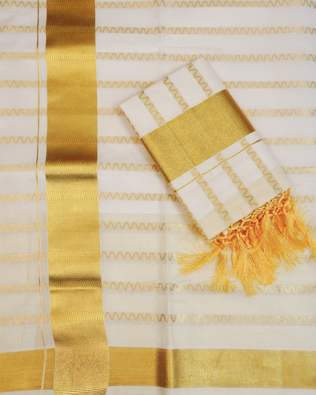 Cream colour cotton set mundu Featuring Gold zari zigzag Strips on body, complemented by classy golden kara.