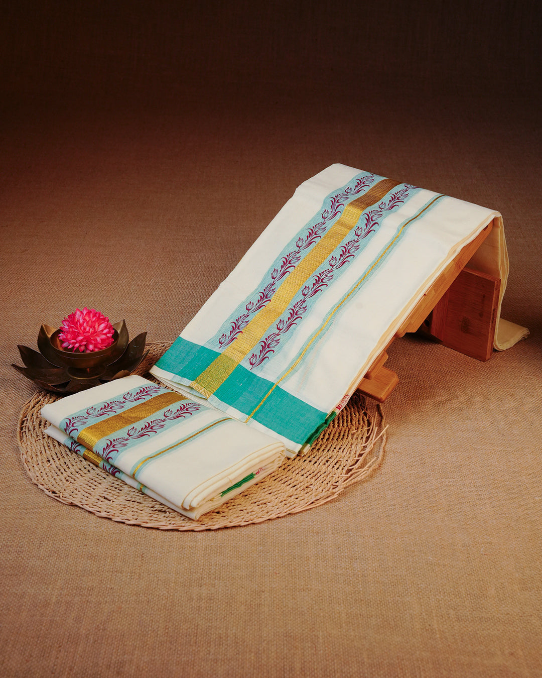 Cream colour Cotton set mundu Featuring Plain body with Gold Zari ,green border with print.