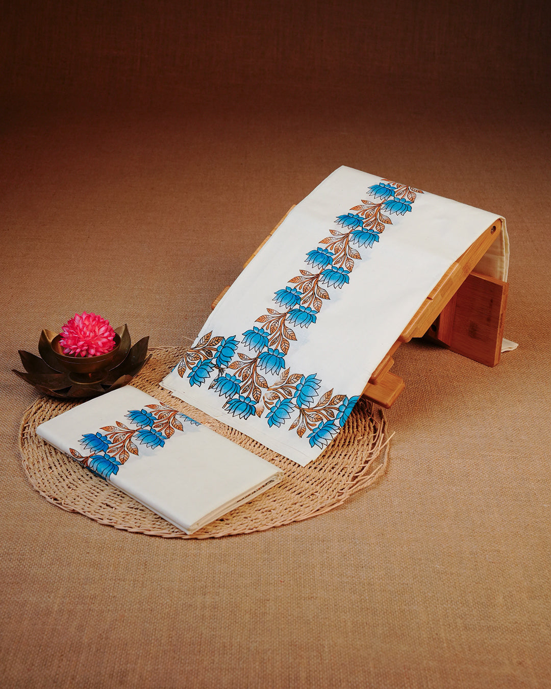 Cream colour cotton set mundu Featuring Elegant plain body, complemented by blue Lotus flower print kara.