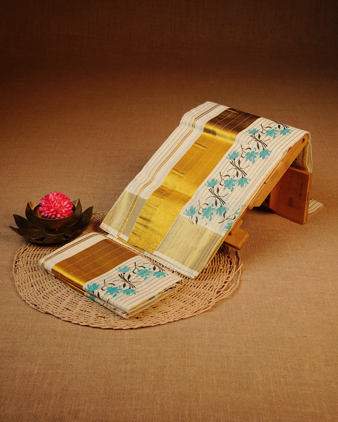 Cream colour cotton Set Mundu With Gold Zari stripes on body, enhanced with gold Kasav With green Floral Printed kara.