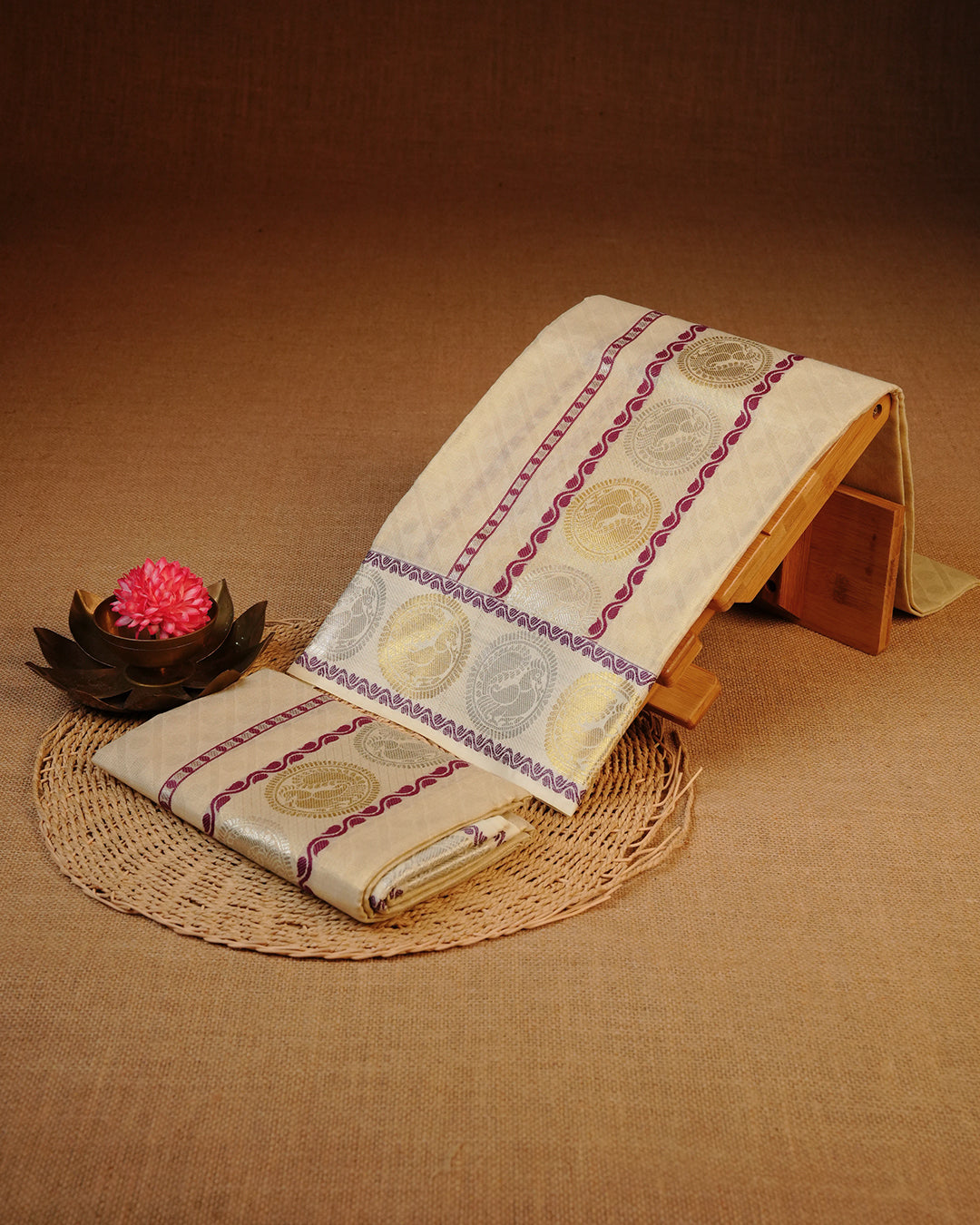 Golden colour Tissue silk set mundu features a plain body accented by a Grape with Gold & Silver Chakra Motifs on border.