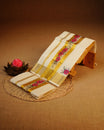Cream colour cotton set mundu featuring plain body, complemented by Floral Print on gold zari Kara.