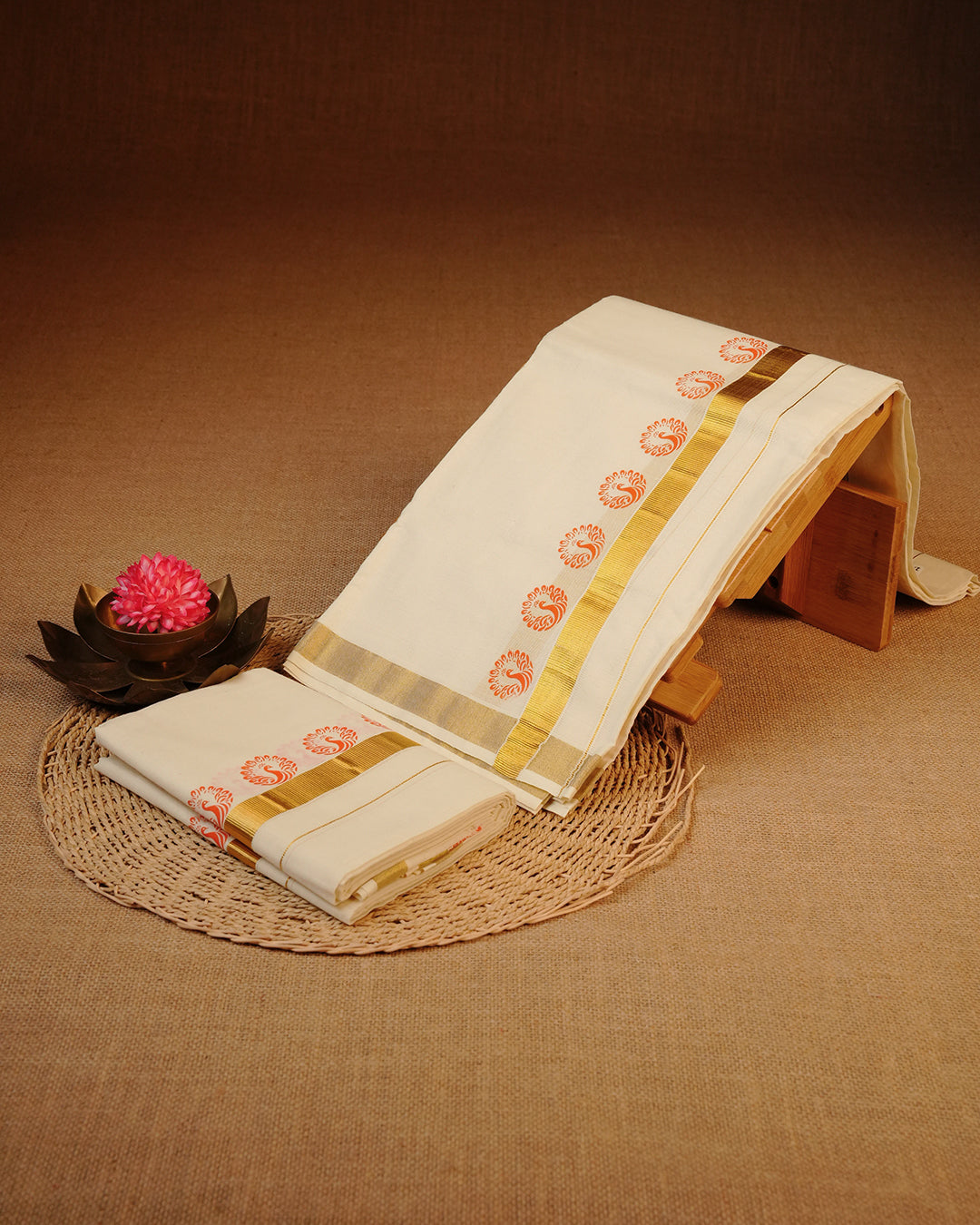 Cream colour cotton Set Mundu With Plain body, enhanced with gold Kasav With Red Peacock Printed kara.