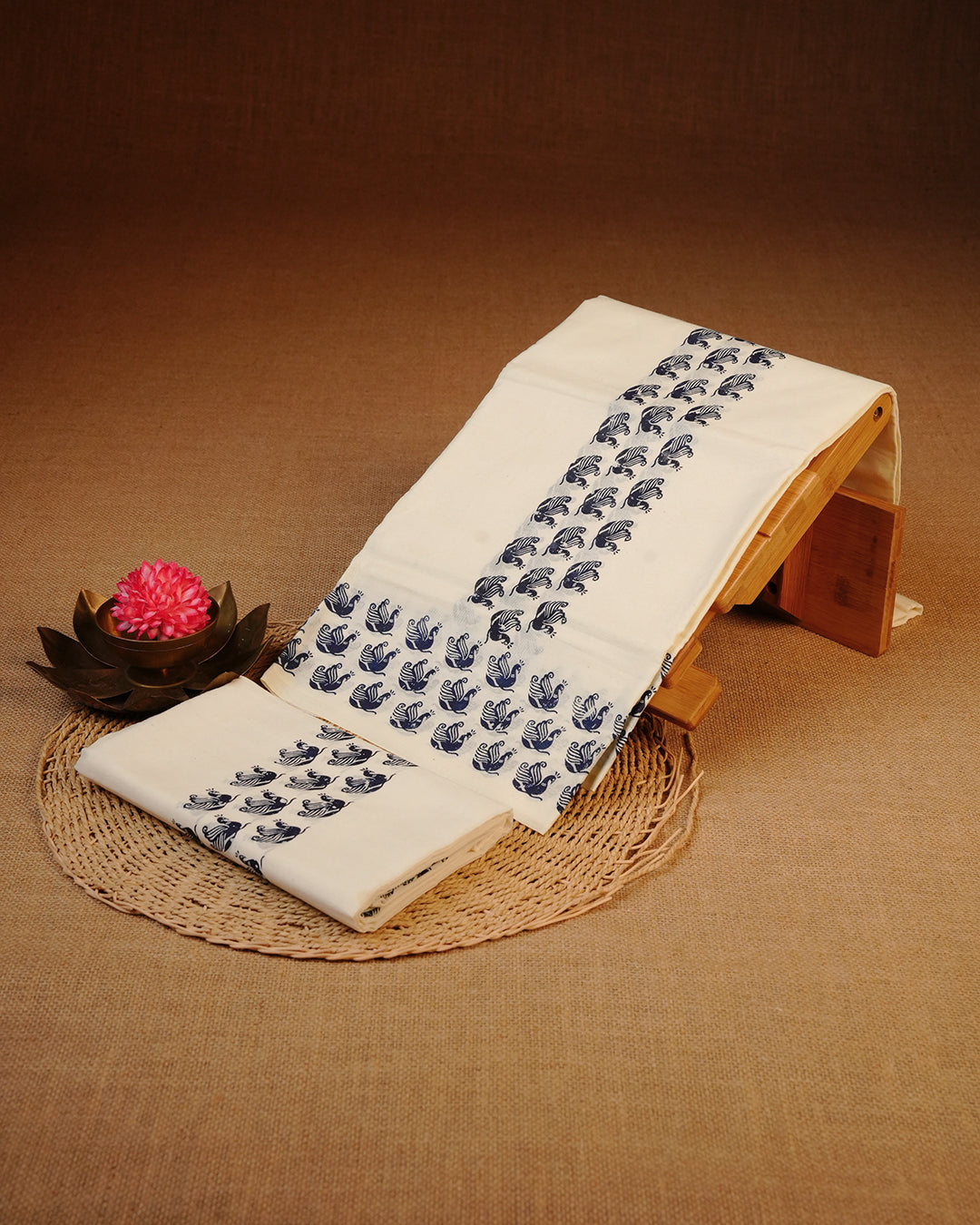 Cream colour cotton Set Mundu Features Plain body, Highlighting Blue colour Peacock Printed border.