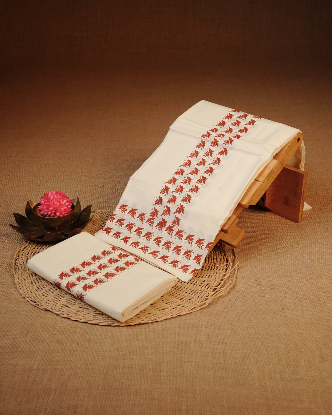 Cream colour cotton Set Mundu Features Plain body, Highlighting Brown colour bird Printed border.