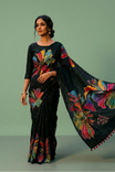 Black colour semi khadi silk saree adorned with yellow, green and magenta colour bold floral motifs across the body, designed without a border for a contemporary touch, and paired with a matching blouse. (Copy)