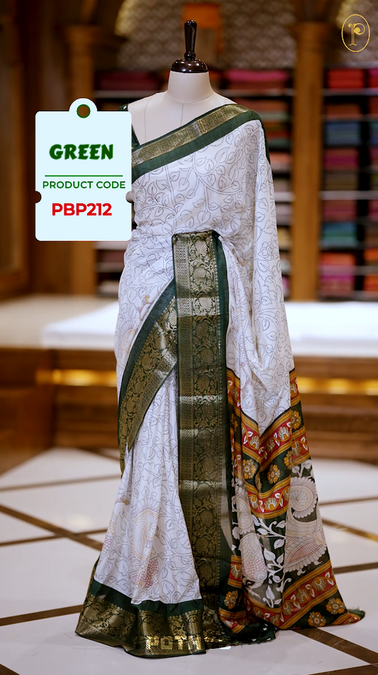 White colour Kalamkari saree featuring intricate prints, paired with a striking green and golden traditional border & The multicolor Kalamkari printed pallu adds vibrant charm, perfectly matched with a coordinating blouse.
