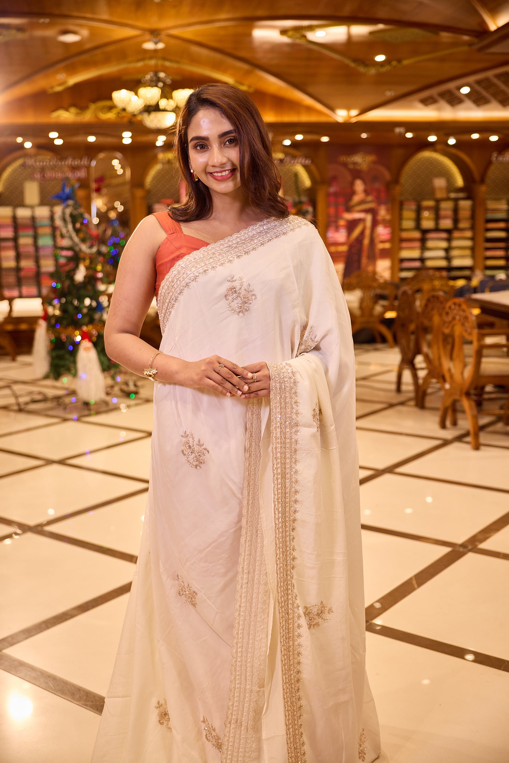 Cream colour pure organza saree with elegant hand embroidery featuring beads, sequins, pearls and thread detailing all over the body, finished with a beautifully crafted scallop border, paired with a matching worked blouse.