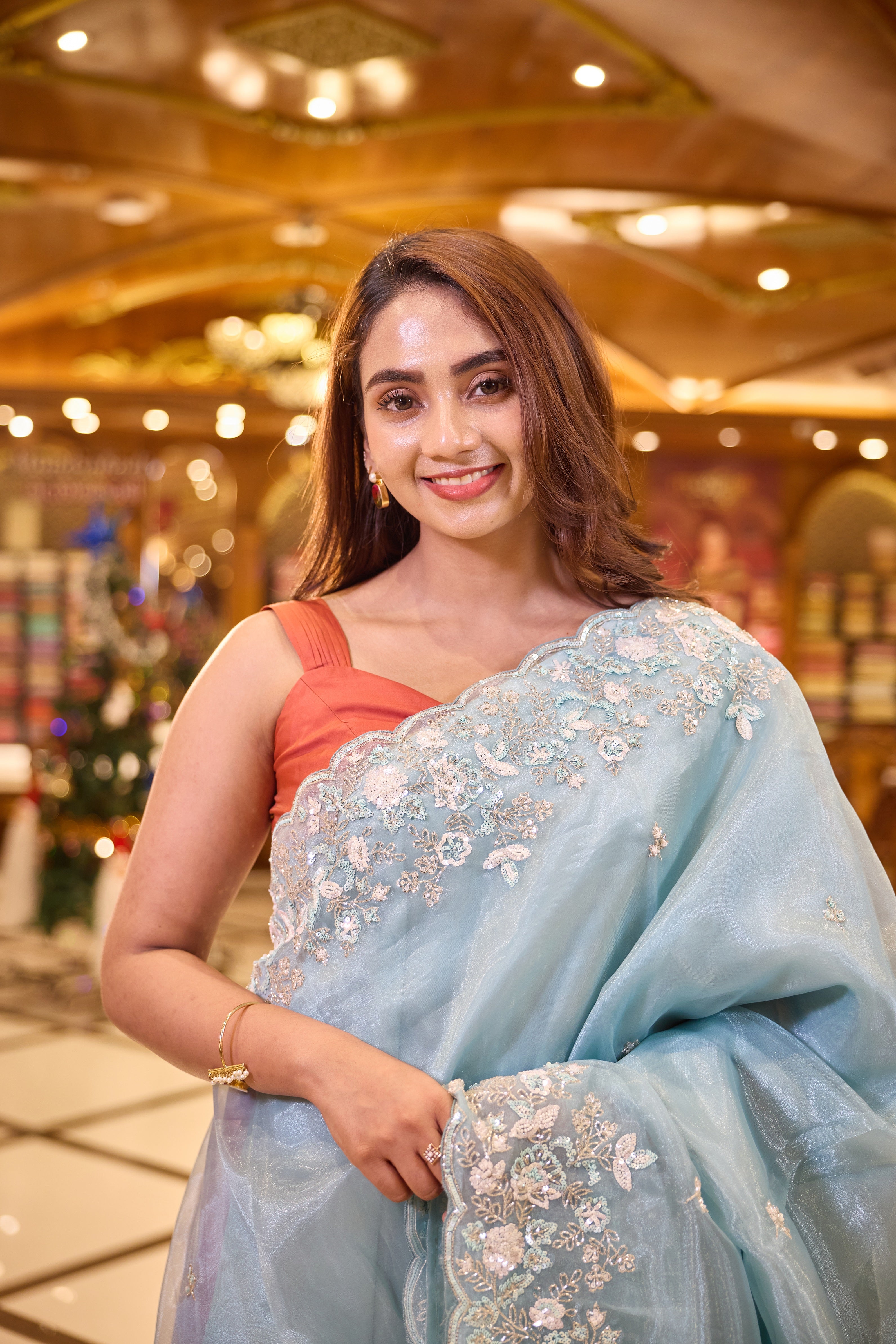 Light Blue colour Premium Designer saree crafted in fine glass organza with exquisite hand embroidered bead and sequin work, finished with an elegant scallop border, Comes with a matching worked blouse.