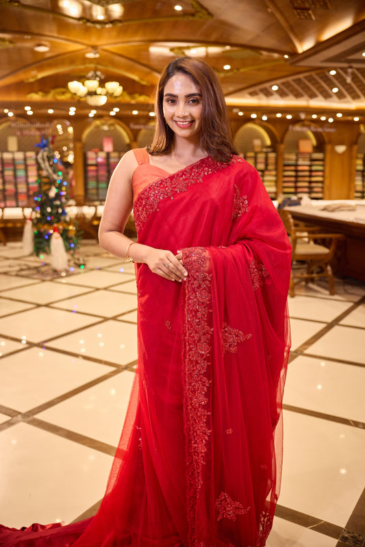 Cherry Red colour Hand dyed Premium Designer Saree, crafted in full net fabric with intricate self colour thread and bead embroidery, finished with an elegant scallop border and paired with a matching worked blouse.