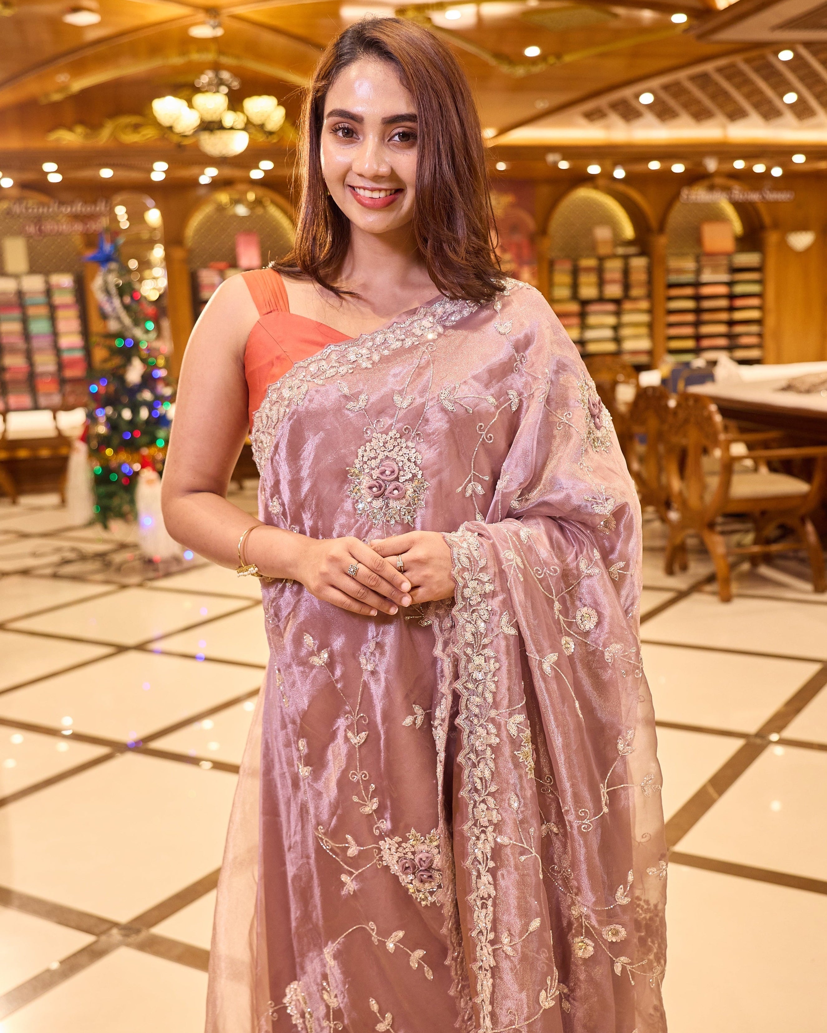 Mauve colour Tissue Organza saree with exquisite hand embroidery Floral work all over the body and a beautifully finished scallop border, paired with a matching worked blouse.
