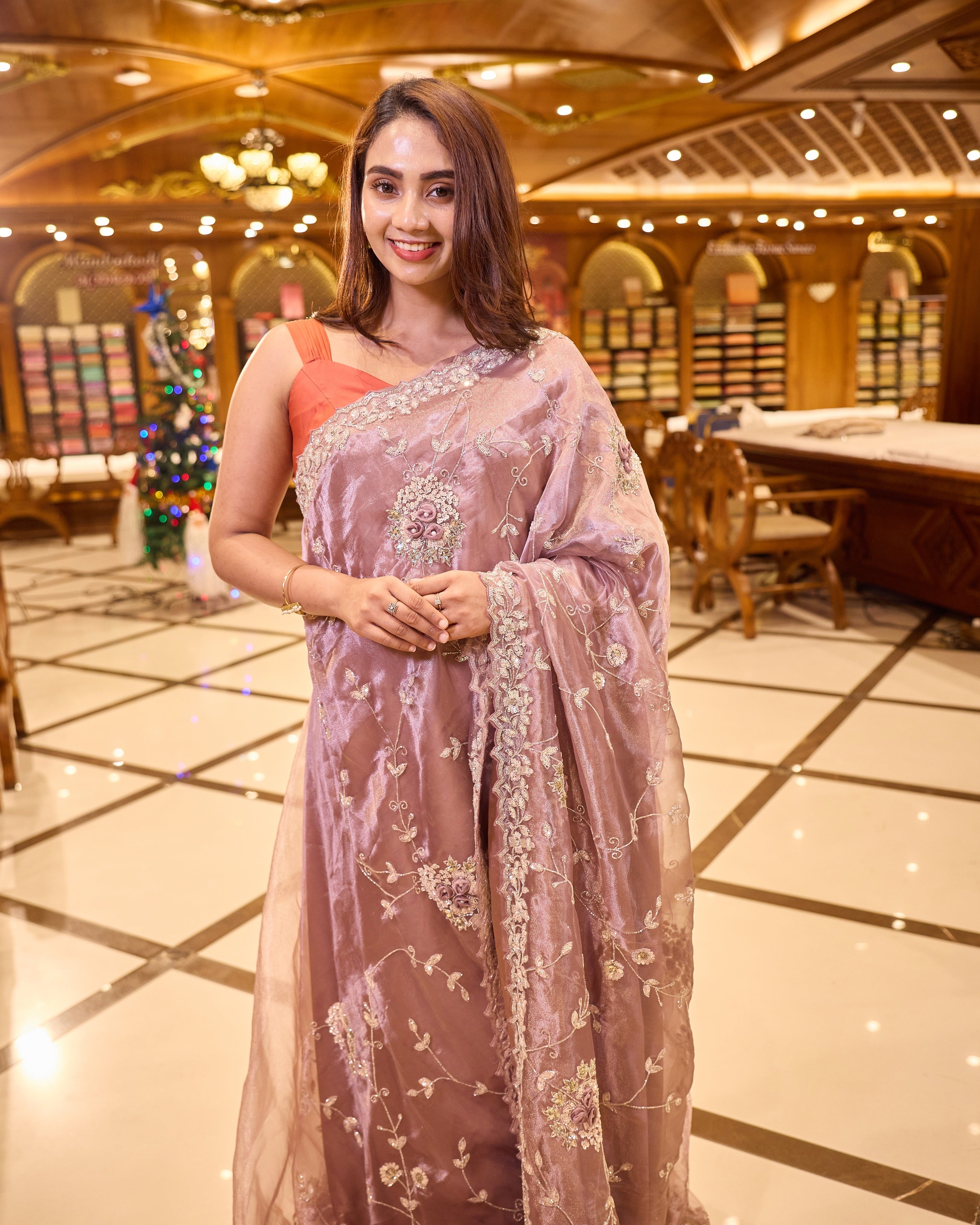 Mauve colour Tissue Organza saree with exquisite hand embroidery Floral work all over the body and a beautifully finished scallop border, paired with a matching worked blouse.