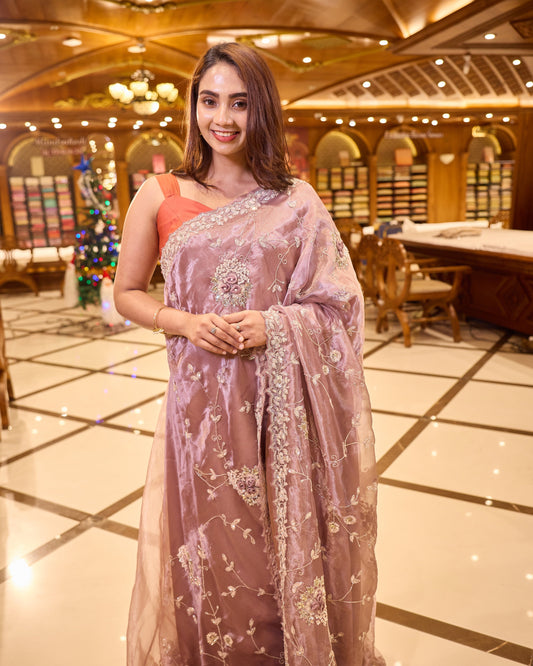 Mauve colour Tissue Organza saree with exquisite hand embroidery Floral work all over the body and a beautifully finished scallop border, paired with a matching worked blouse.