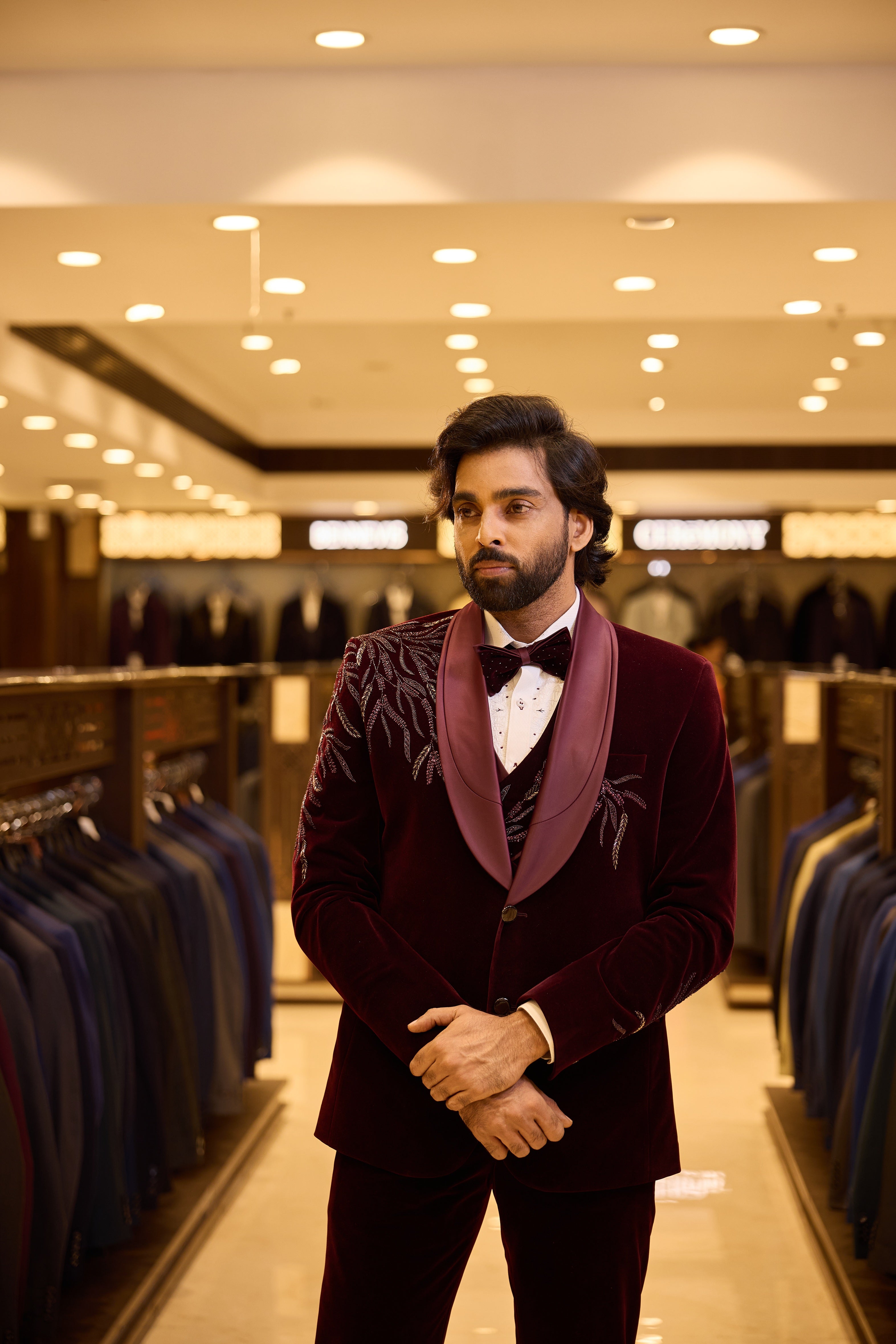Rich maroon two tone velvet groom wear by BENNIVES, elevated with special stone work and a stylish neck d’xesto lapel for an elegant, luxurious wedding look.