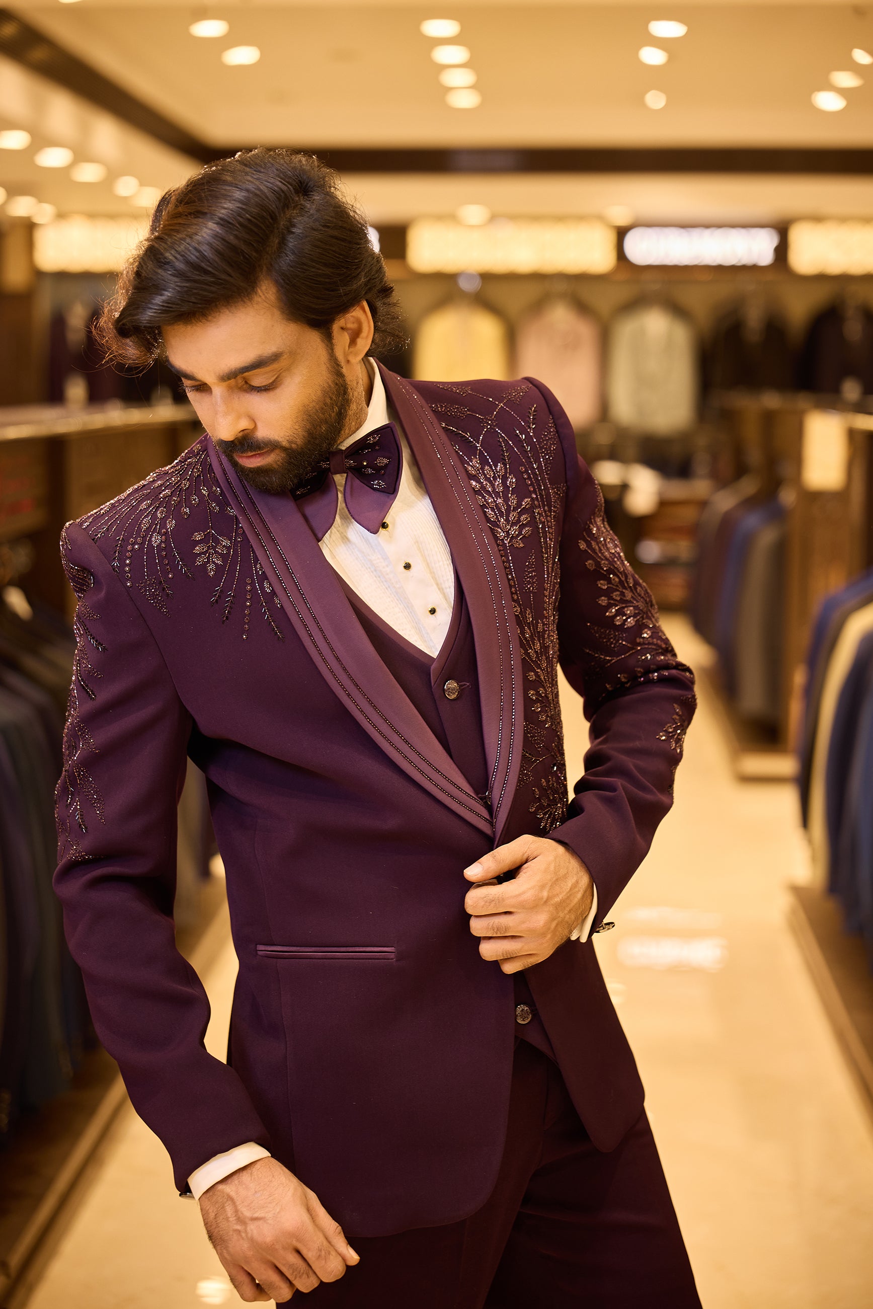 Rich purple colour 5 piece tuxedo suit crafted in premium polynosic fabric, featuring gold tone leaf beadwork all over and finished with a sleek satin lapel and single button closure for a regal groom look