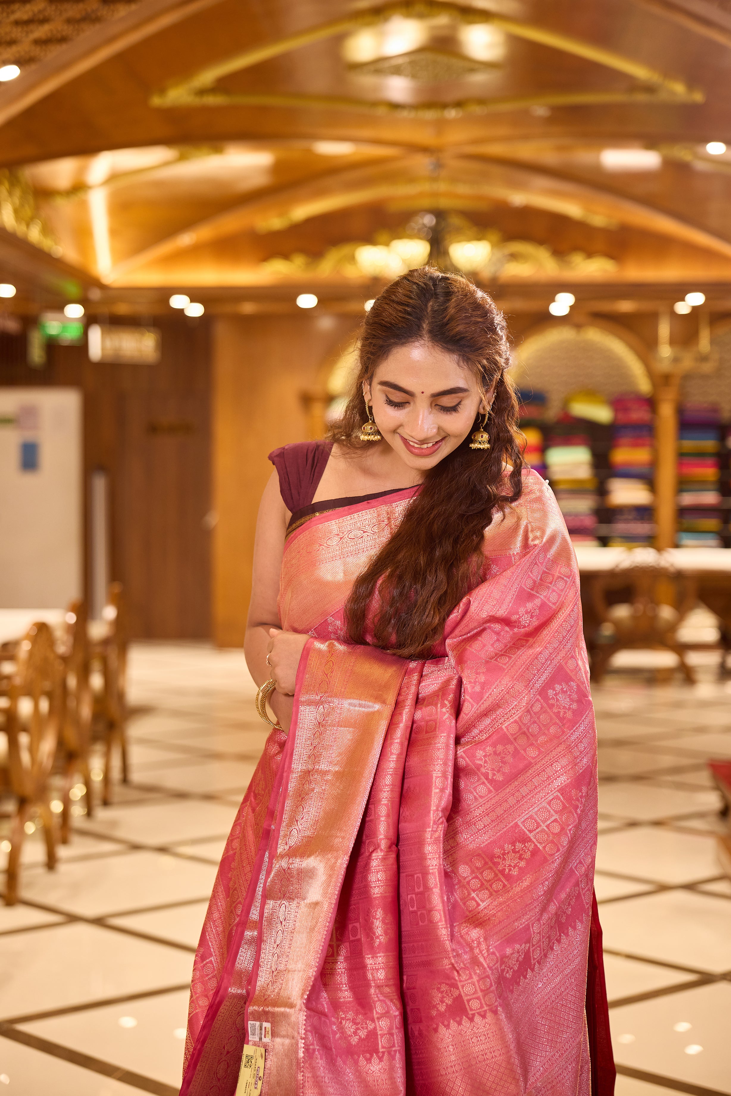 Plush Pink colour Kancheepuram Samudrika Silk Saree featuring multi pattern geometric jacquard weaving with rich antique gold Zari detailing, complemented by a matching designer jacquard blouse piece.