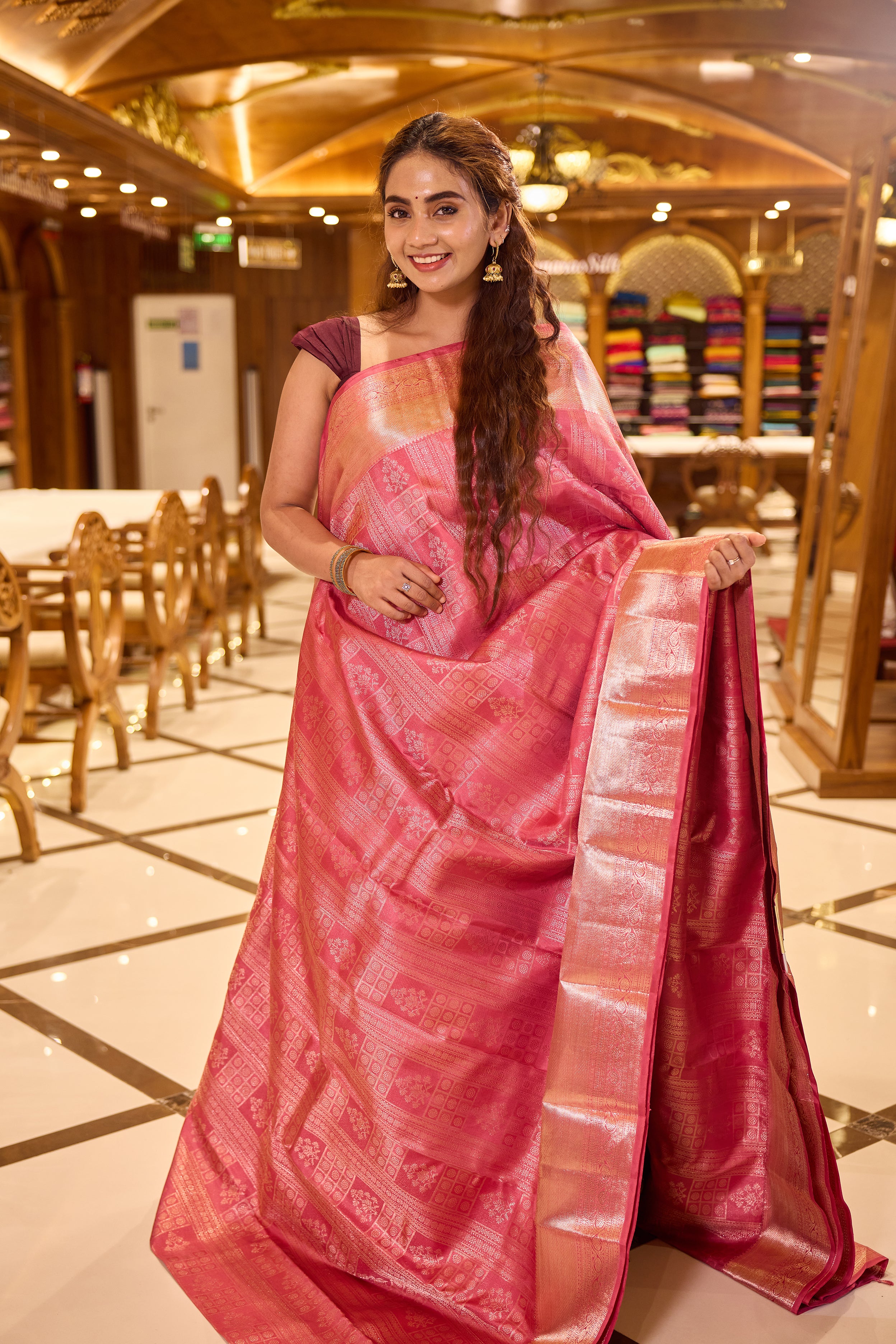 Plush Pink colour Kancheepuram Samudrika Silk Saree featuring multi pattern geometric jacquard weaving with rich antique gold Zari detailing, complemented by a matching designer jacquard blouse piece.