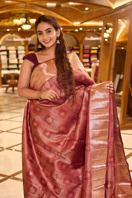 Coral Red Kanchipuram Samudrika Silk Saree featuring a heritage box pattern wedding jacquard with rich antique copper jari weaving, paired with a matching designer jacquard blouse piece.