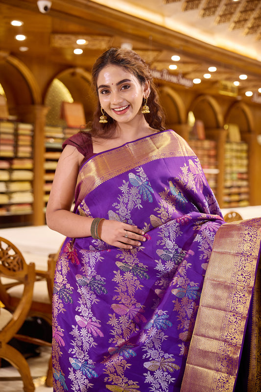 Royal purple colour Renkath Kancheepuram Samudrika Silk Saree with rich gold zari jacquard featuring intricate floral and bird motifs, complemented by a traditional zari border and paired with a matching blouse piece.