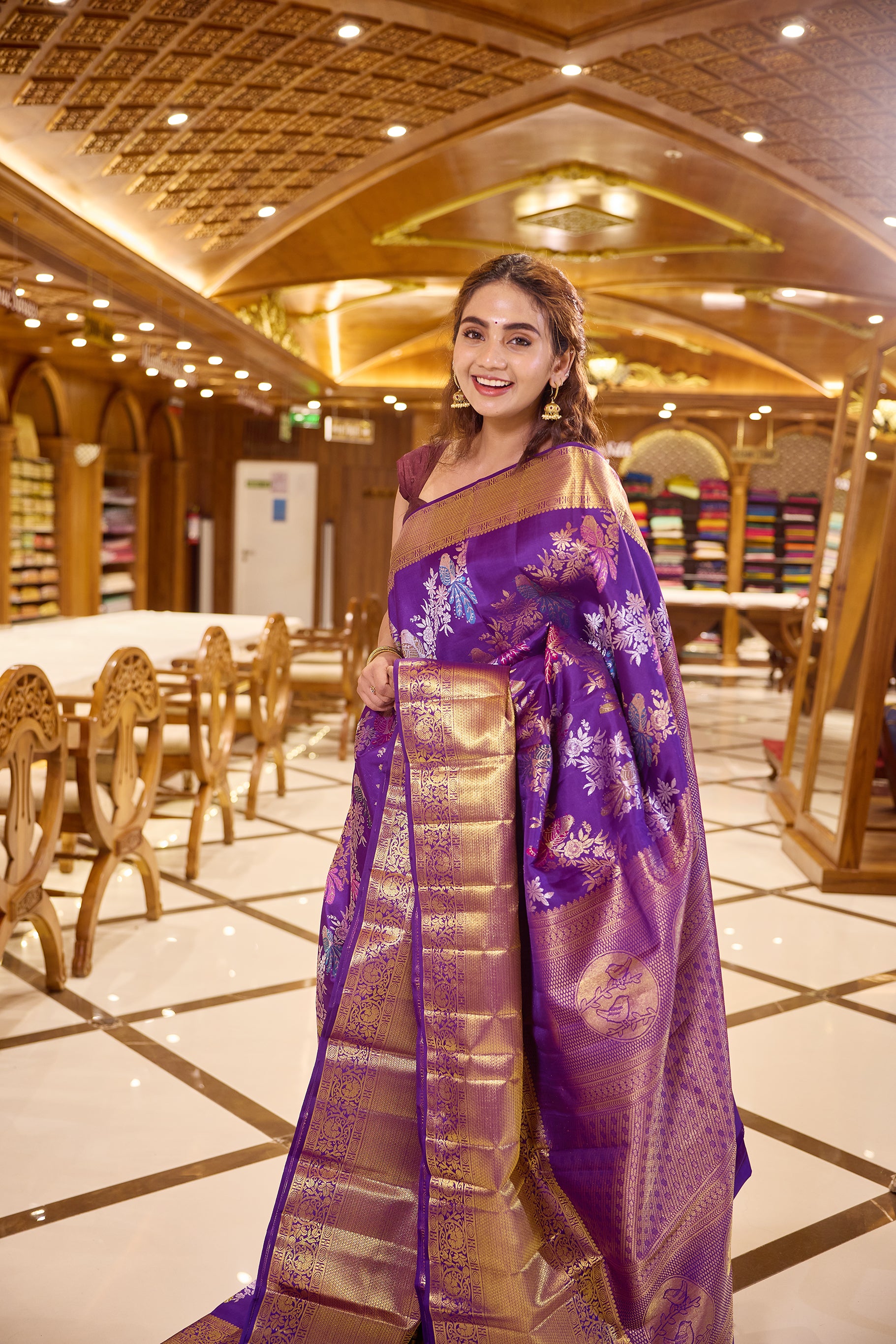 Royal purple colour Renkath Kancheepuram Samudrika Silk Saree with rich gold zari jacquard featuring intricate floral and bird motifs, complemented by a traditional zari border and paired with a matching blouse piece.