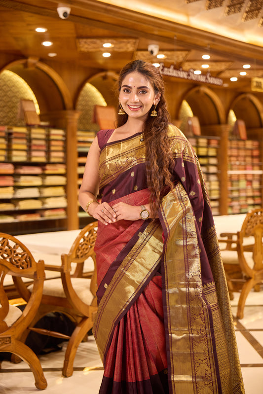Maroon & Brown Shade Kanchipuram Traditional Handloom Silk Saree featuring vaira oosi zari checks on the body with contrasting Mayuri chakra motifs woven in rich antique gold zari, elegantly finished with a classic gold zari border.