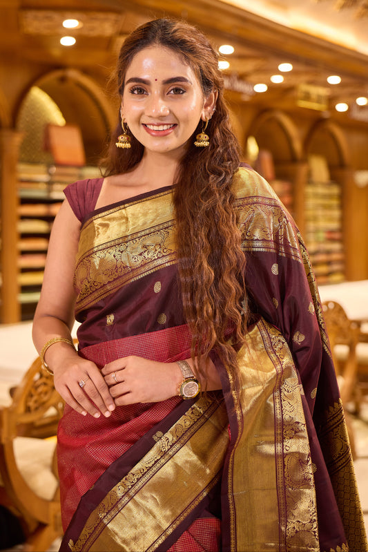 Maroon & Brown Shade Kanchipuram Traditional Handloom Silk Saree featuring vaira oosi zari checks on the body with contrasting Mayuri chakra motifs woven in rich antique gold zari, elegantly finished with a classic gold zari border.